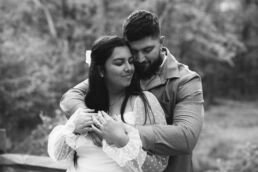 Couple posing on a wooden bridge at Cedar Creek Park during an engagement photography session